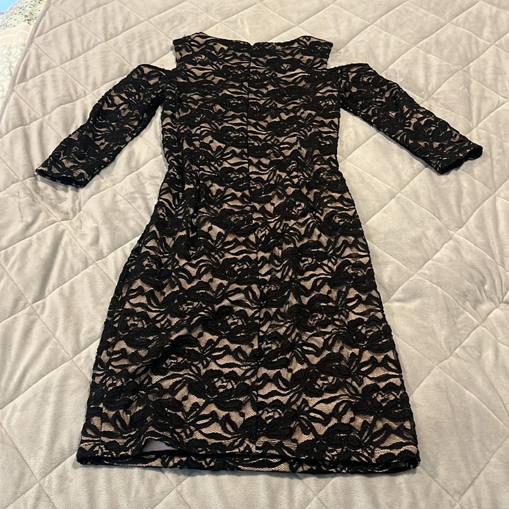 Black lace “cold shoulder” dress. Sheer black lace, cream liner. Back zipper.